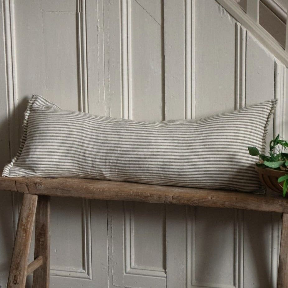 Esmee Olive Stripe Linen Bolster cushion the ideal companion for a rustic wooden bench or window seat. A true statement piece.