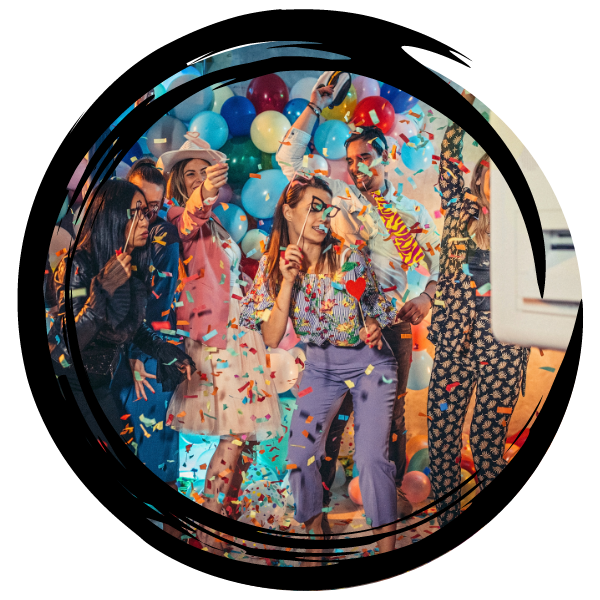 People celebrating with balloons and confetti at a colorful party