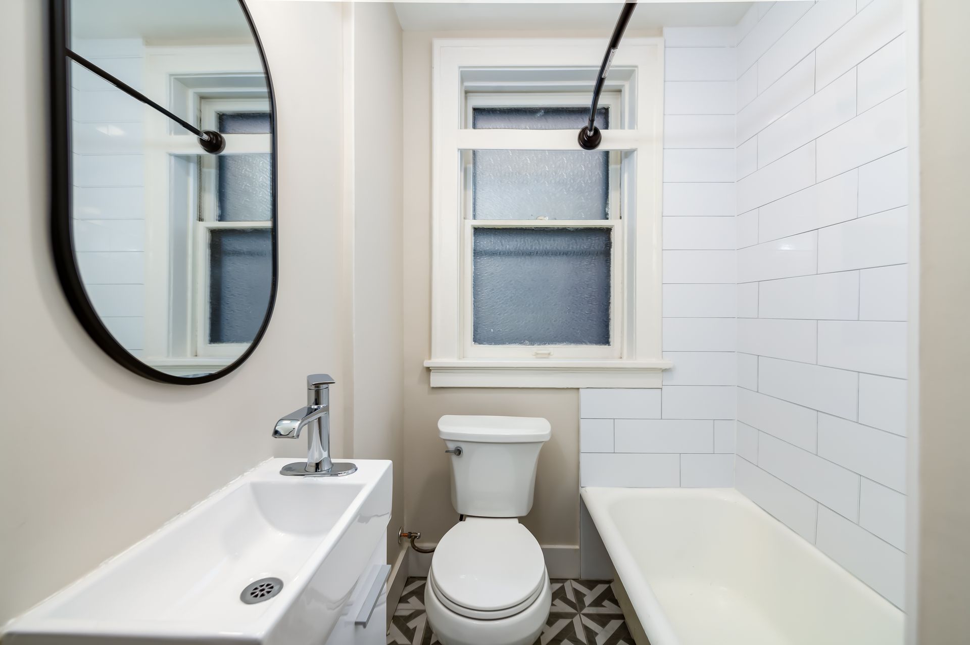 A bathroom with a toilet , sink , and bathtub.