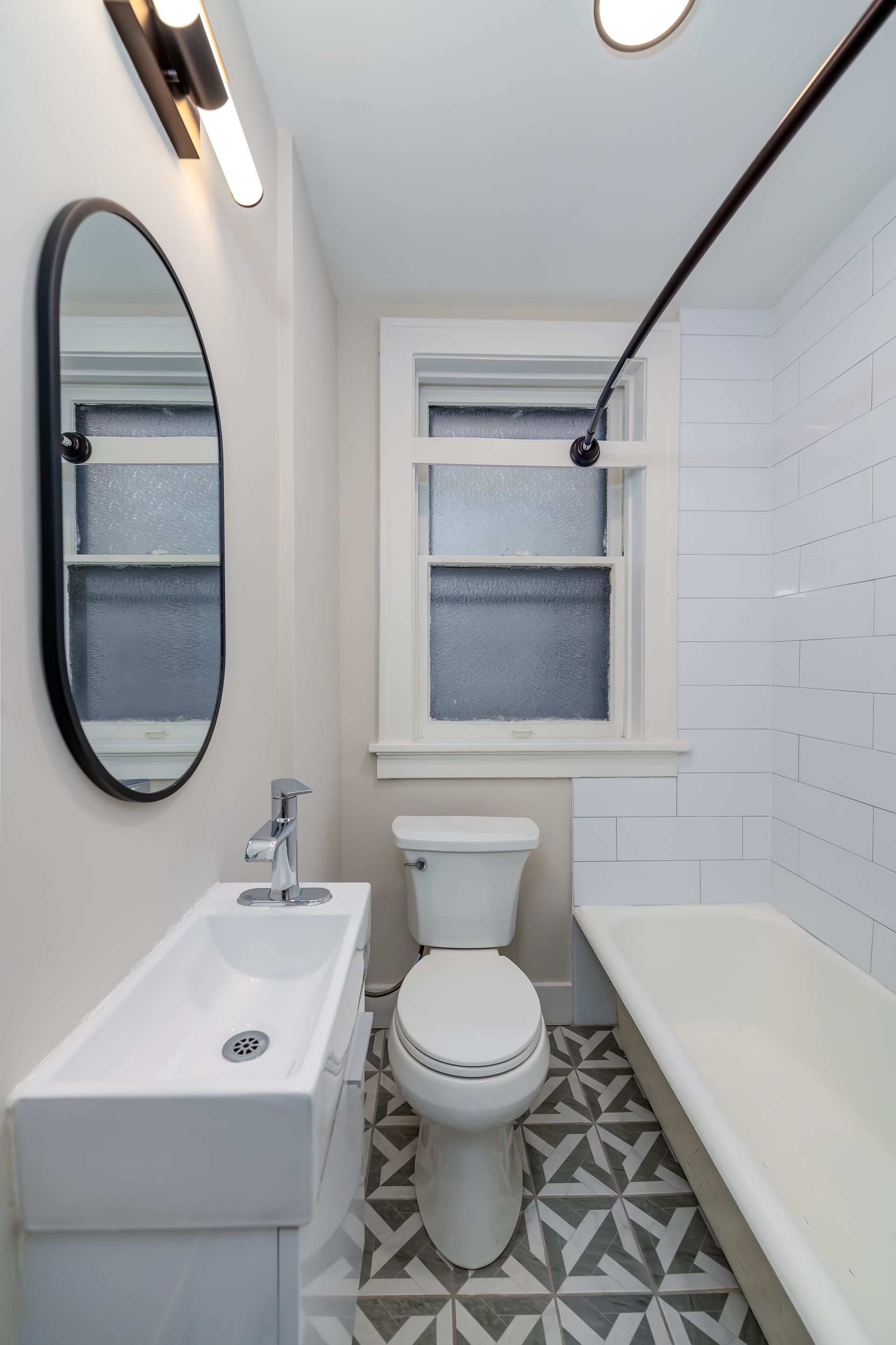 A bathroom with a toilet , sink , and bathtub.