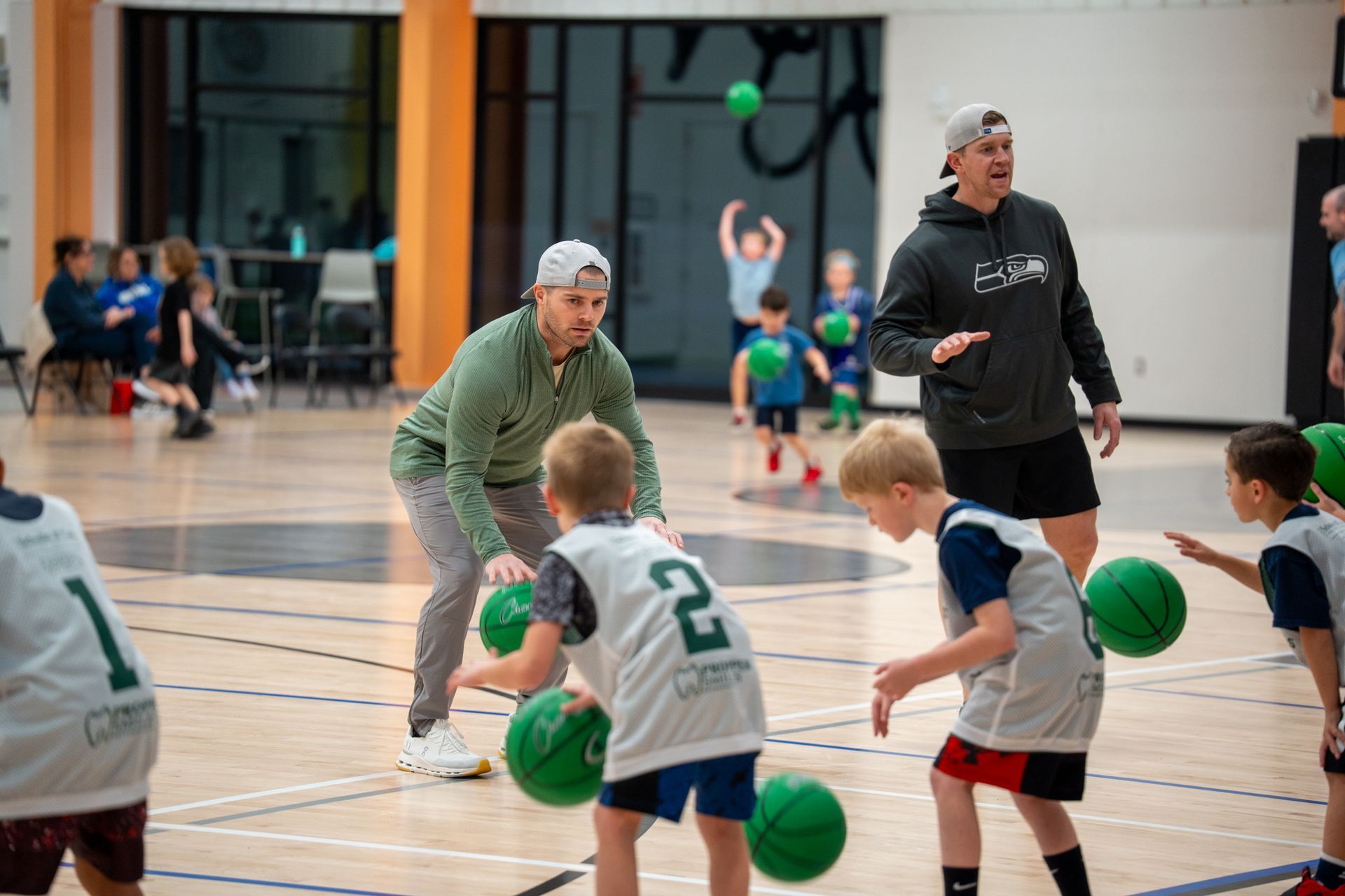 Adult and kids practicing basketball