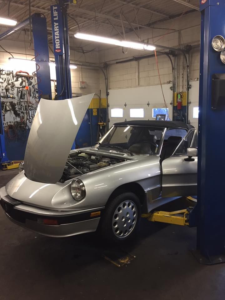 Silver Car On Lift Inside Professional Auto Repair Shop | Swedish Imports