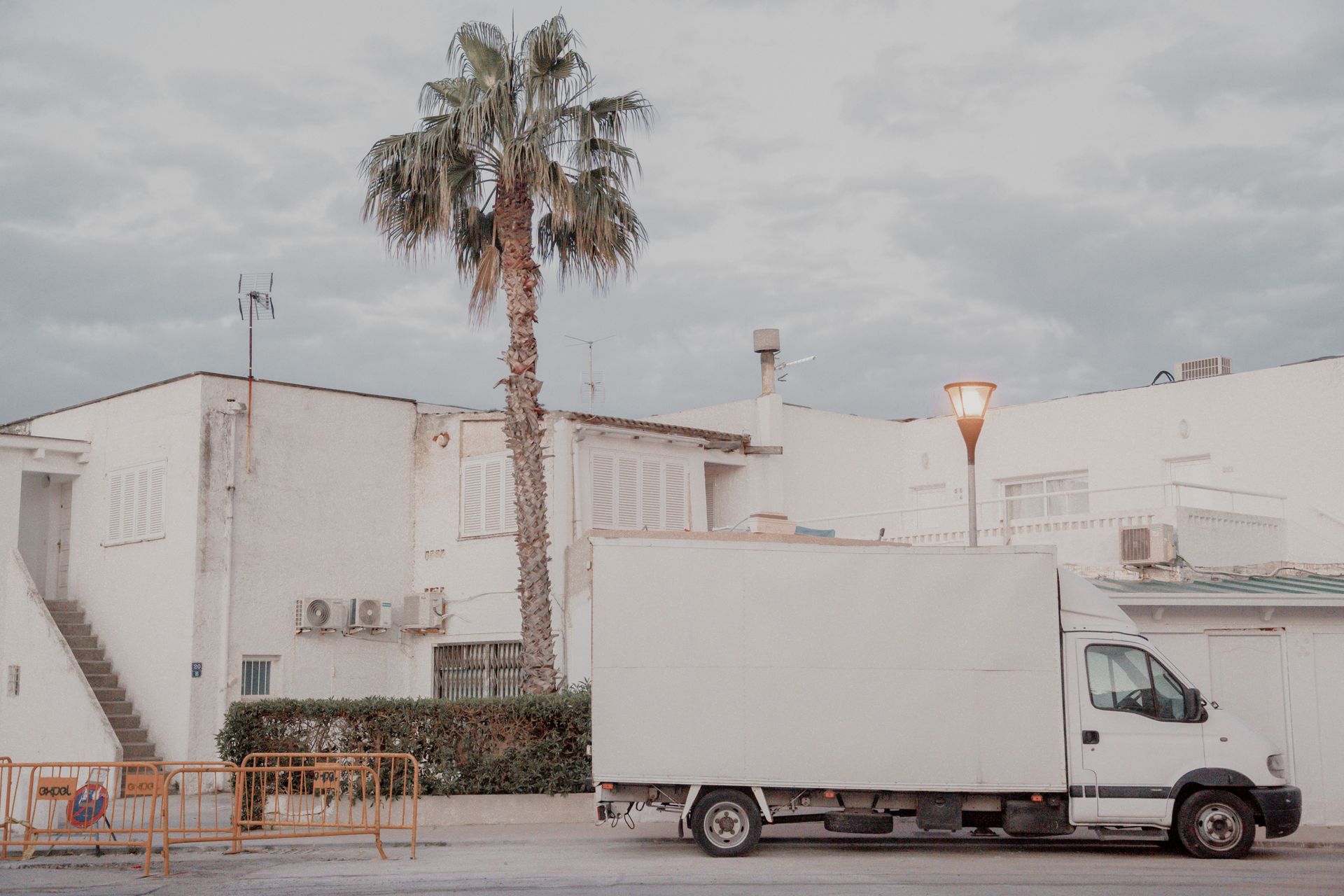 Moving truck parked outside a suburban home during a household relocation