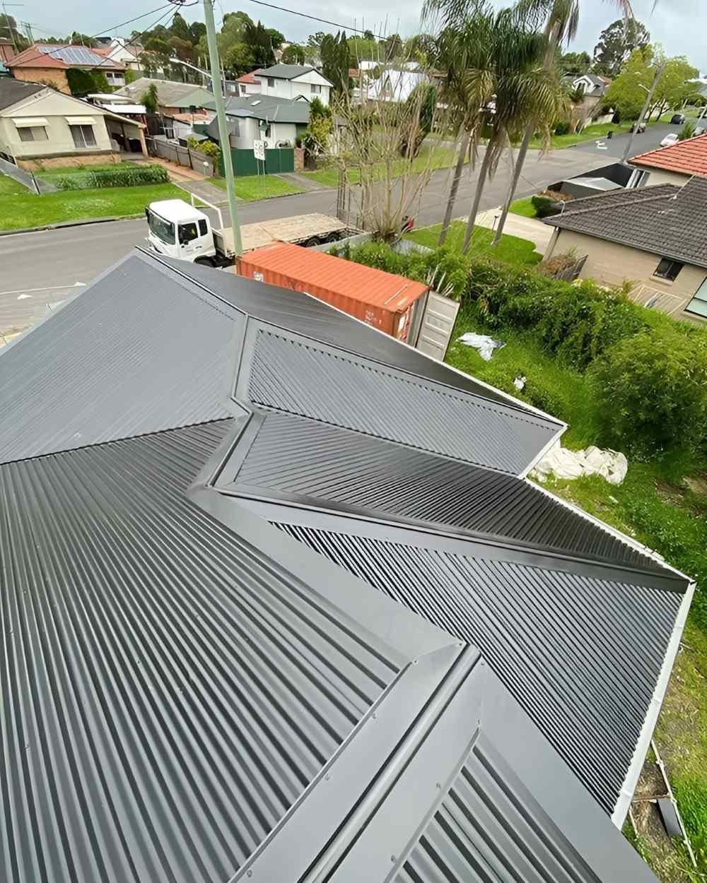 An Aerial View of a House With a Corrugated Metal Roof — Lake Valley Roofing in Thornton, NSW