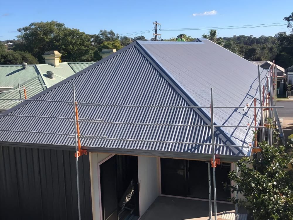 An Aerial View of a House With a Corrugated Metal Roof — Lake Valley Roofing in Cardiff, NSW