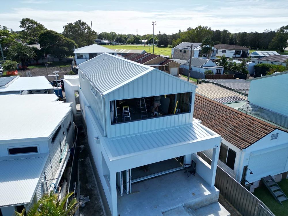 An Aerial View of a House Under Construction in a Residential Area — Lake Valley Roofing in Broadmeadow, NSW