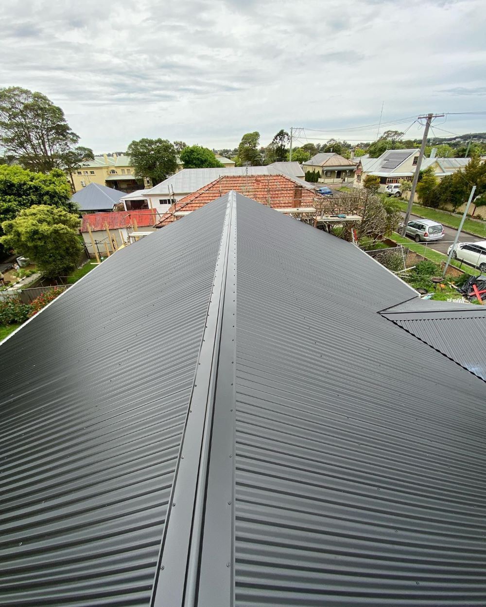 The Roof of a House is Covered in a Black Roofing Material — Lake Valley Roofing in Hamilton, NSW