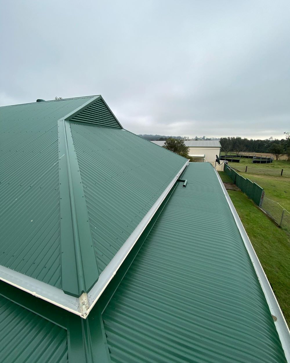 A Green Roof of a House With a View of a Body of Water — Lake Valley Roofing in Kotara, NSW