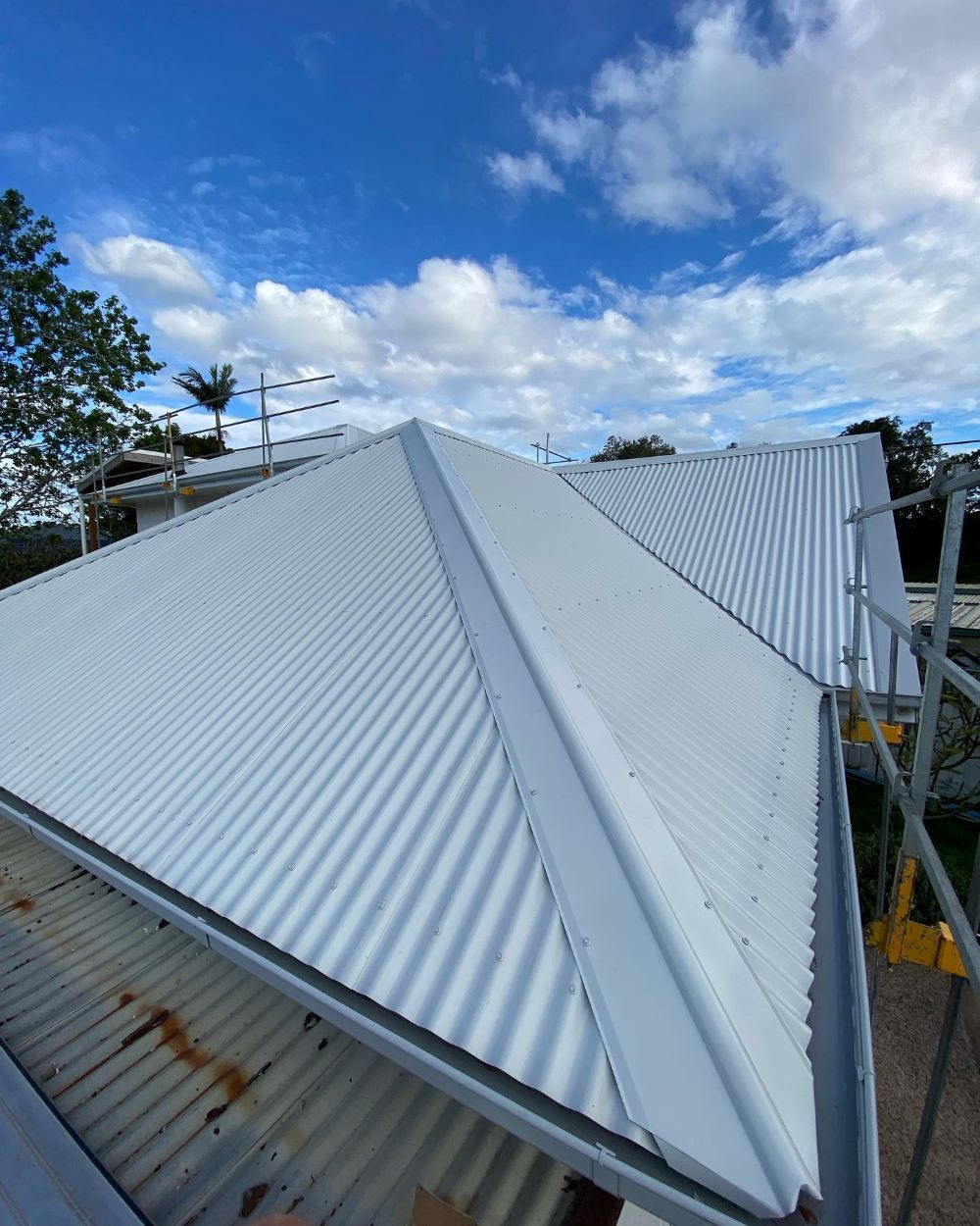 A White Roof With a Blue Sky in the Background — Lake Valley Roofing in Merewether, NSW
