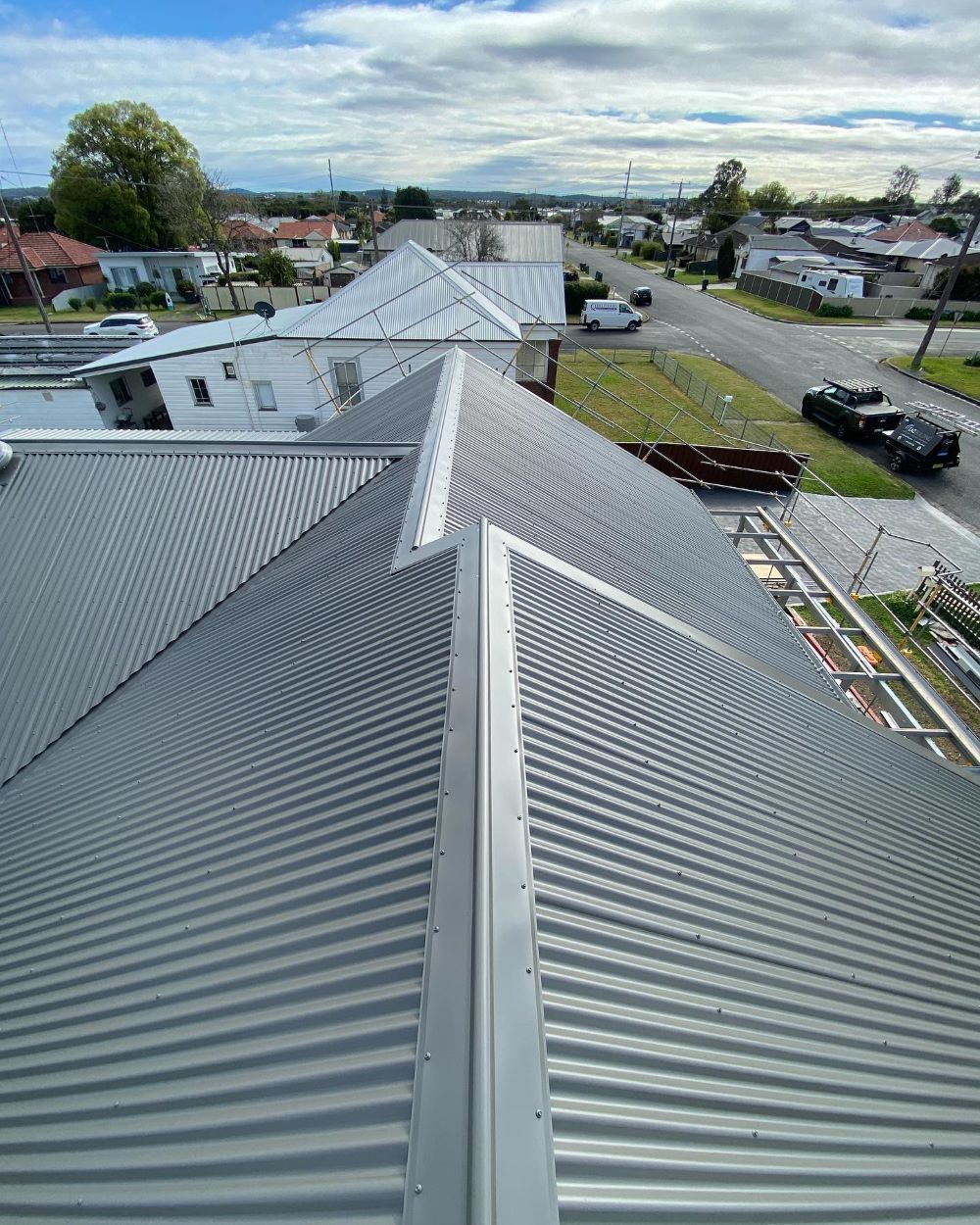 An Aerial View of a Roof With a Street in the Background — Lake Valley Roofing in New Lambton, NSW