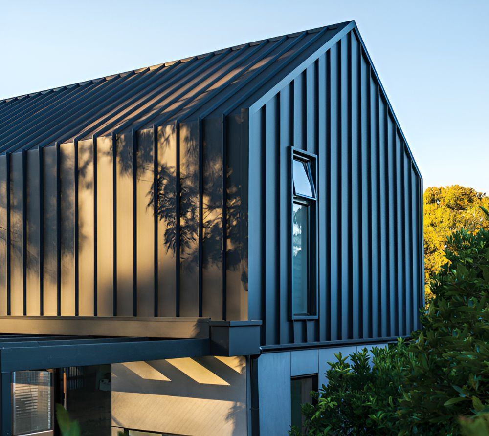 A Black House With a Roof That Looks Like a Barn — Lake Valley Roofing in Newcastle, NSW