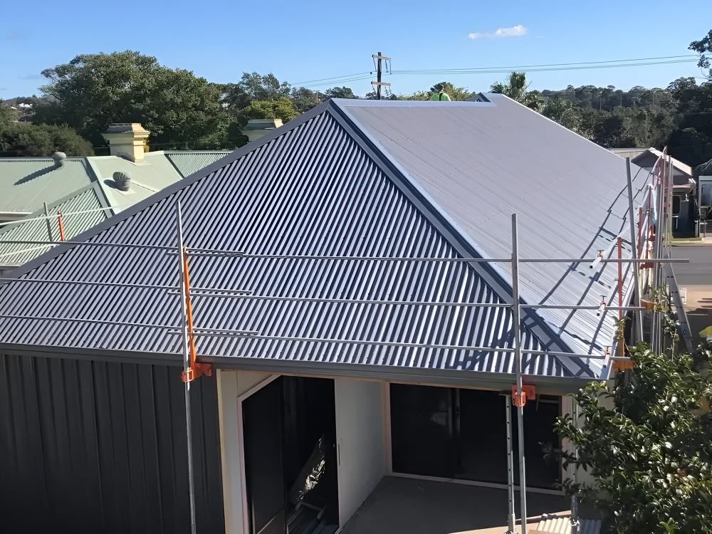 An Aerial View of a House With a Corrugated Metal Roof — Lake Valley Roofing in Wickham, NSW