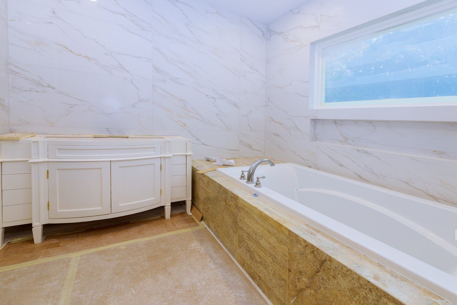 bathtub beside the cabinet