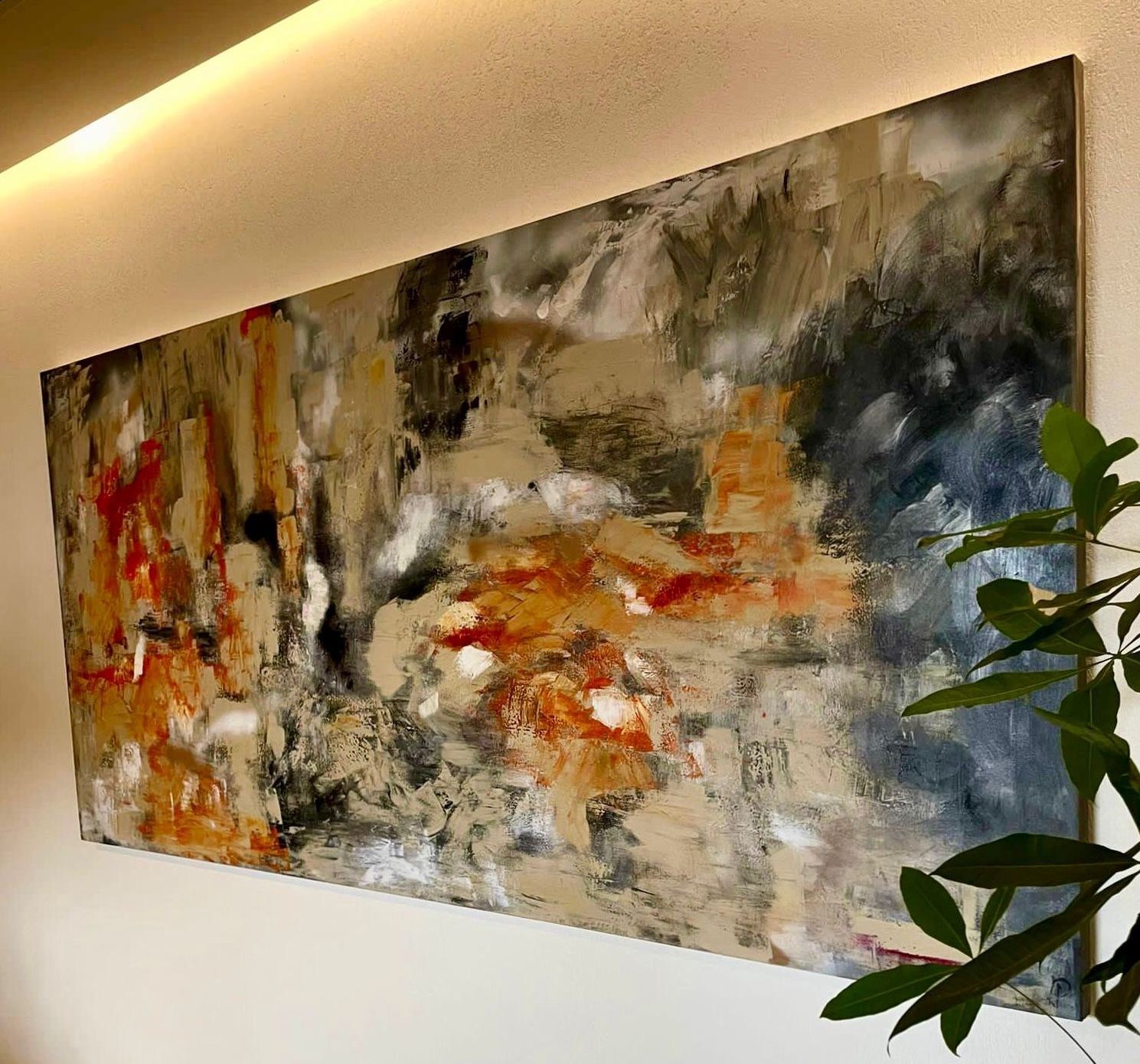 Abstract painting with orange, beige, gray, and blue brushstrokes. Displayed on a wall near a plant.