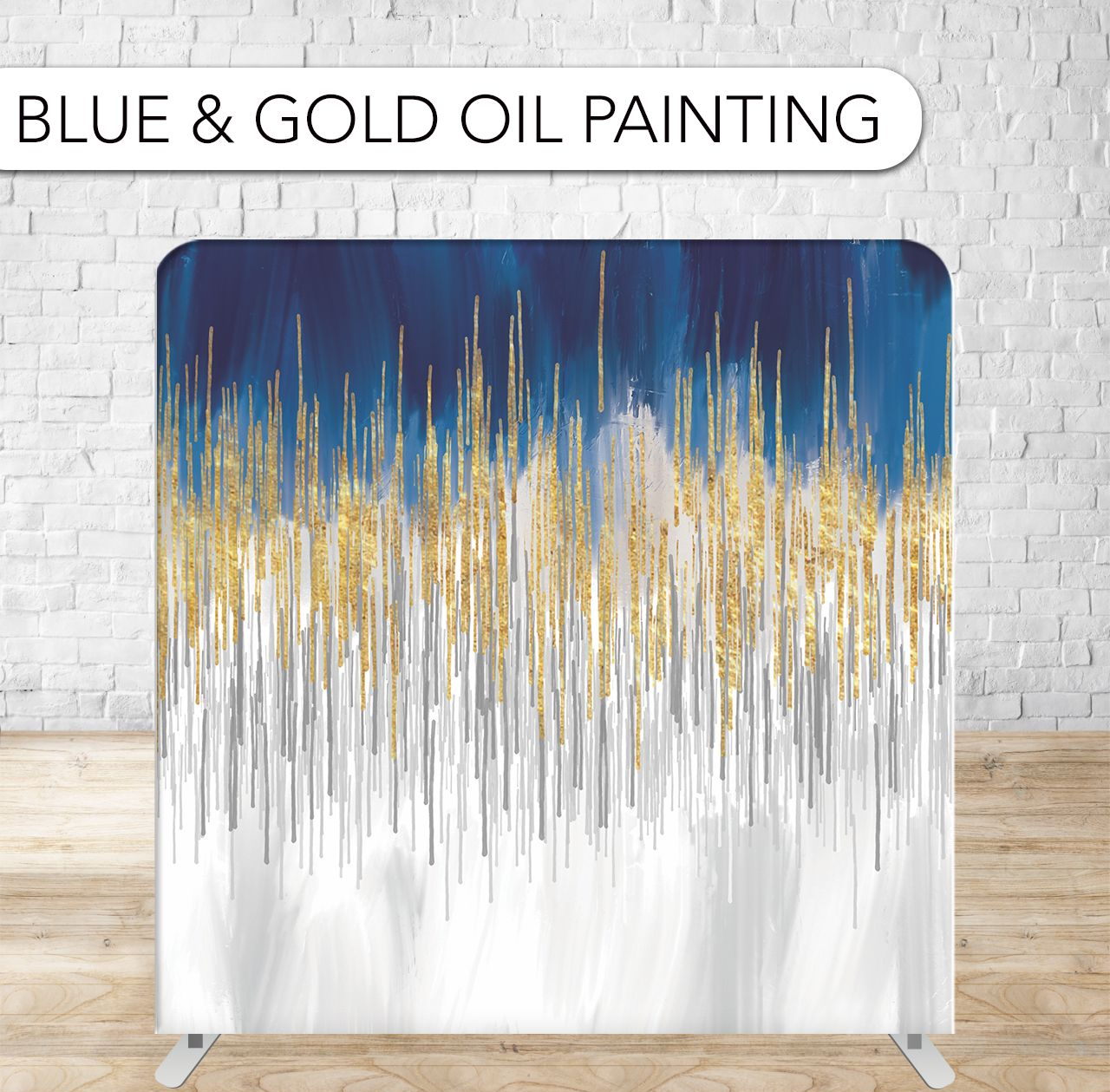 Blue, gold, and white abstract oil painting on a stand against a white brick wall.