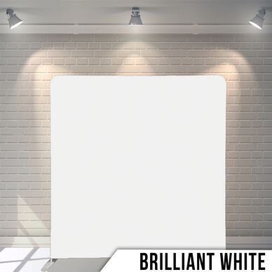 A white square is sitting in front of a brick wall.