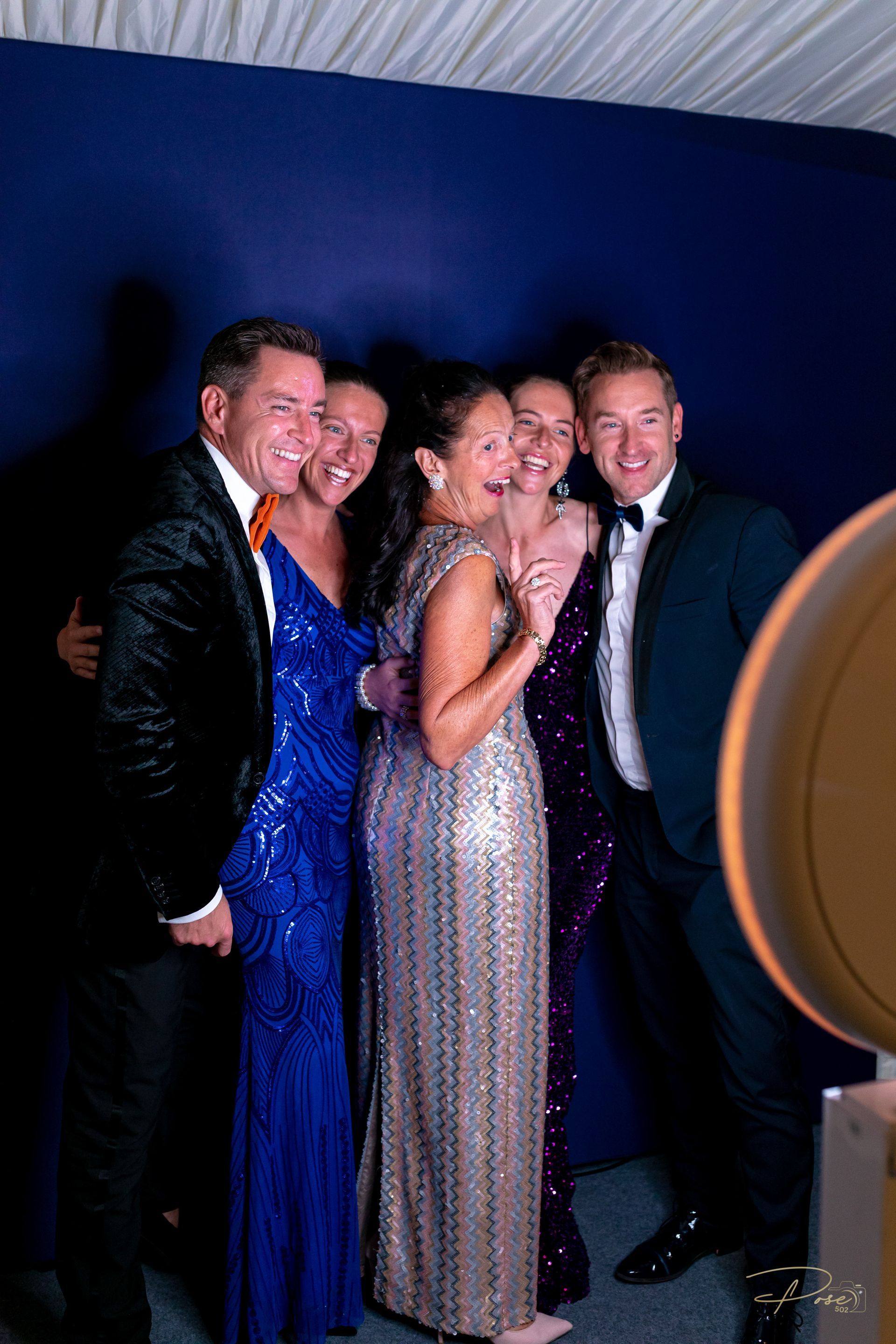 A group of people are posing for a picture in a photo booth.