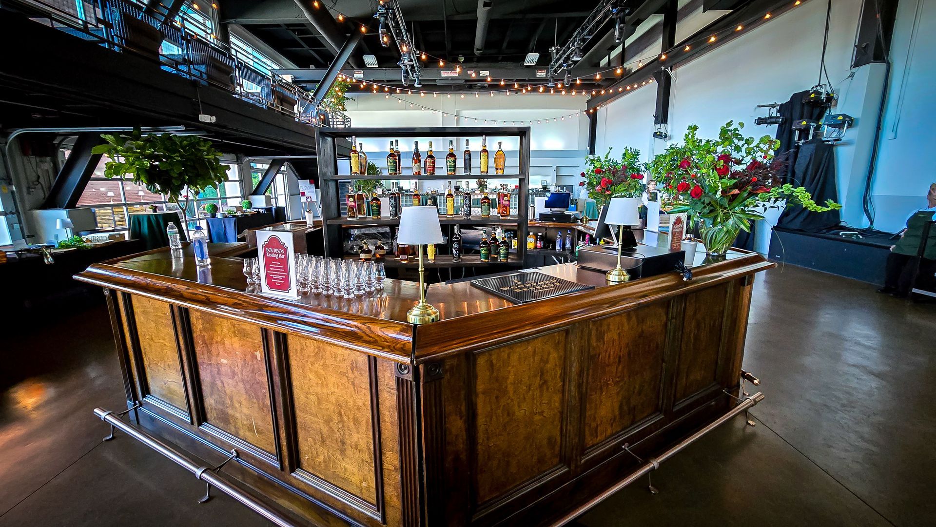 The Ice House industrial event room with a wood bar and string lights, East Washington Street, Louisville