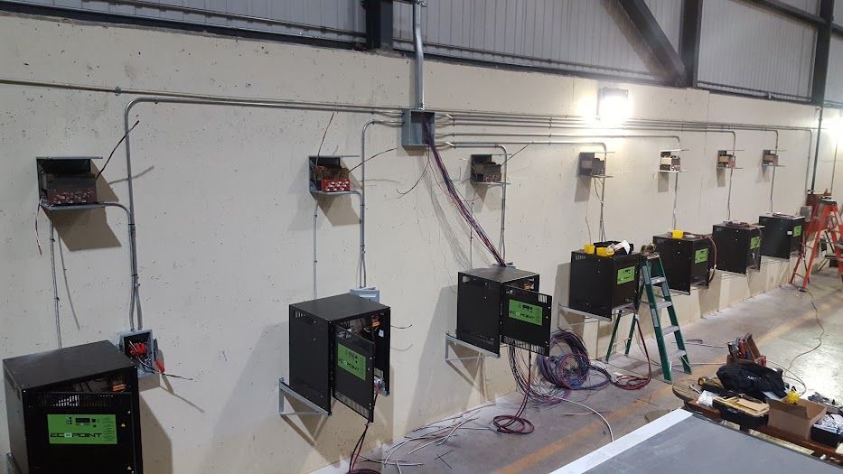 A warehouse with a lot of electrical equipment on the wall.