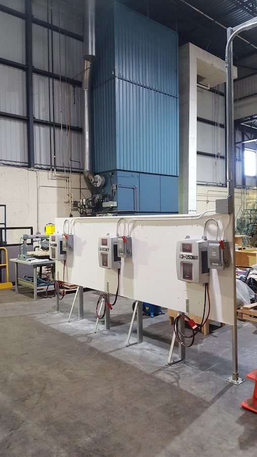 A large machine is sitting in the middle of a warehouse.