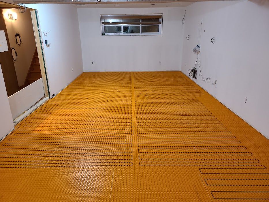A room with a yellow floor and white walls