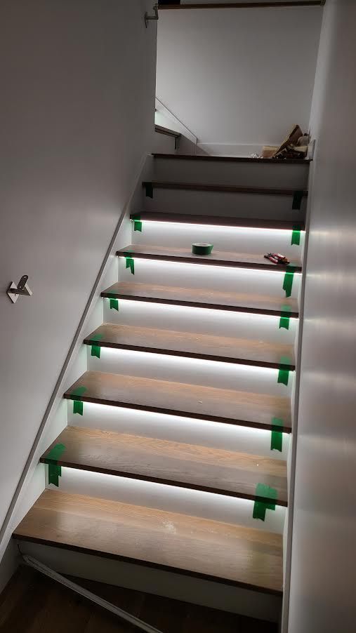 A set of stairs with lights on the steps.