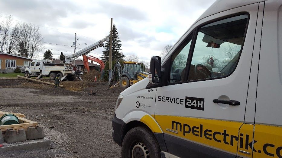 A white and yellow van is parked in front of a construction site.