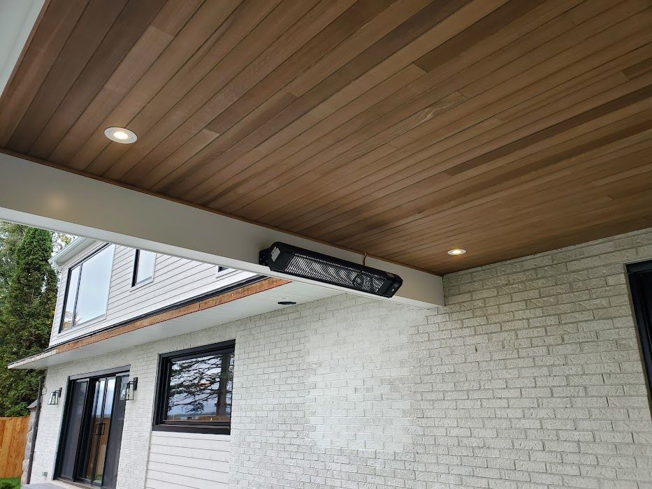 A white brick house with a wooden ceiling.