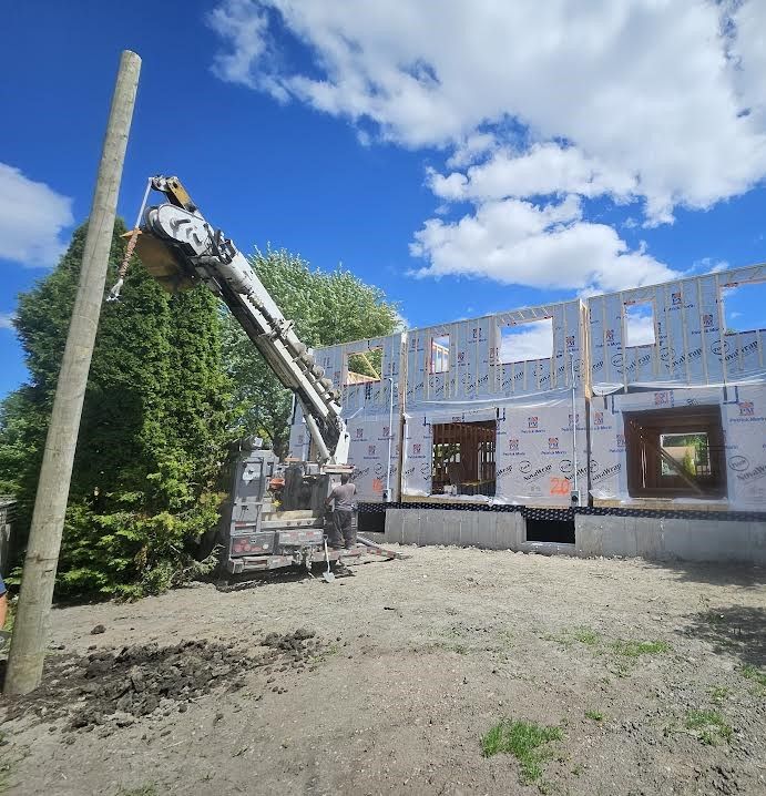 A building under construction with a crane in front of it