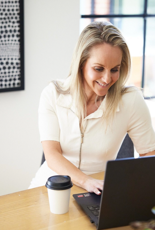 Kym recruiting with a laptop in the office