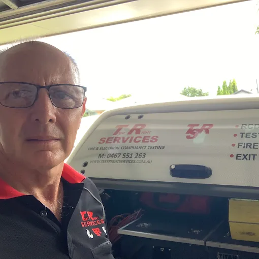 A Man Wearing a Hard Hat Is Using a Fire Extinguisher — Test Right Services in Kirwan, QLD