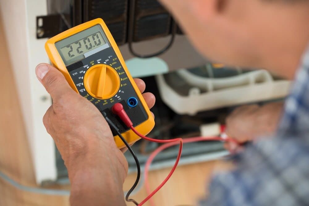 A Person Is Using a Multimeter to Test a Circuit Board — Test Right Services in Kirwan, QLD