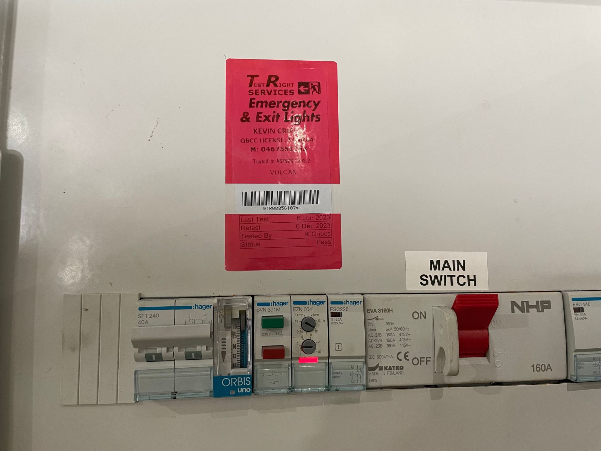 Electrical panel with red labels, switches, and a