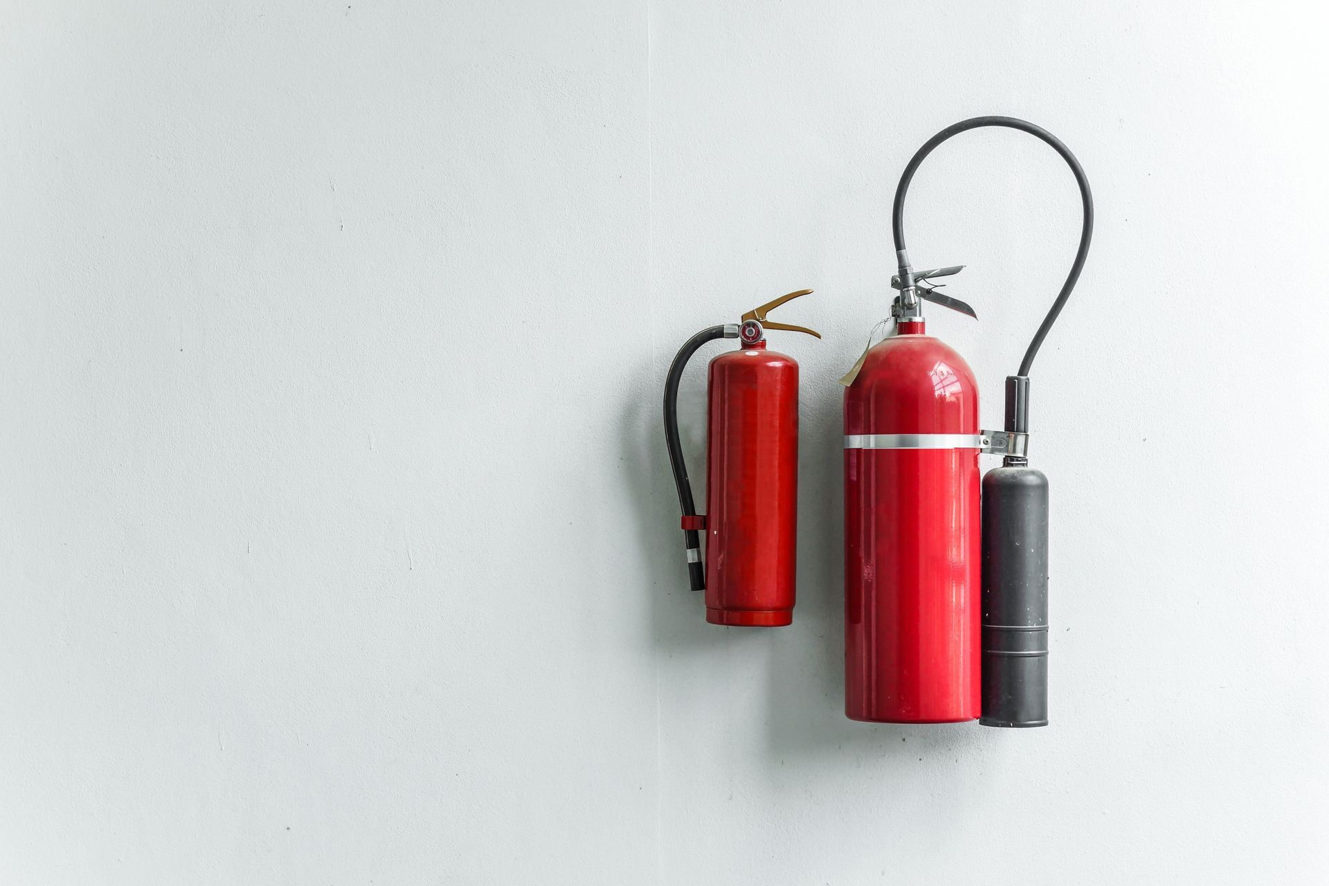 A Man Is Using a Fire Extinguisher to Put out A Fire 
