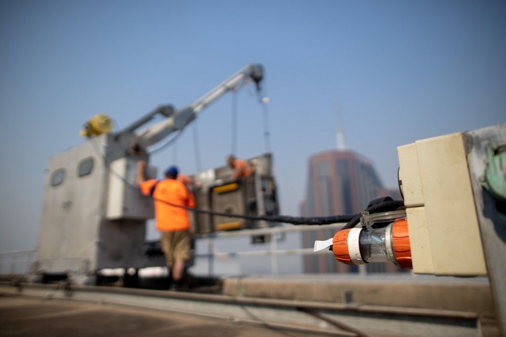 Workers Using a Crane on A Rooftop — Test Right Services in Ayr, QLD 