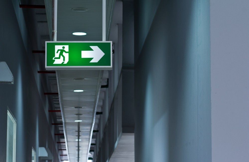 A Green Illuminated Exit Sign — Test Right Services in Ayr, QLD