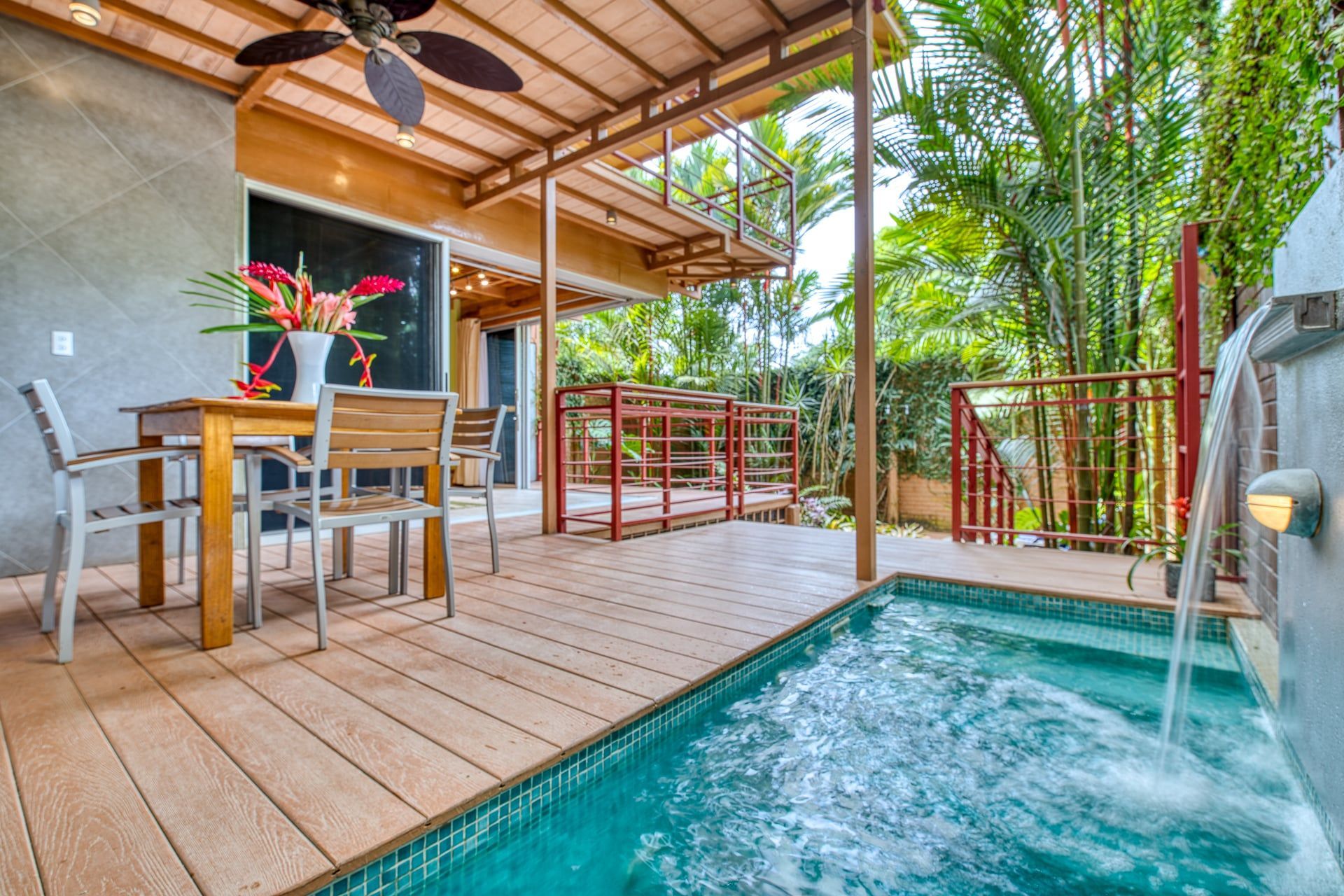 There is a swimming pool in the backyard of a house.