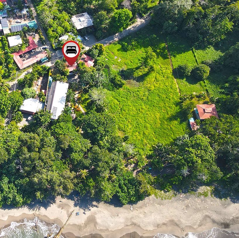 An aerial view of a residential area with a red pin pointing to a house