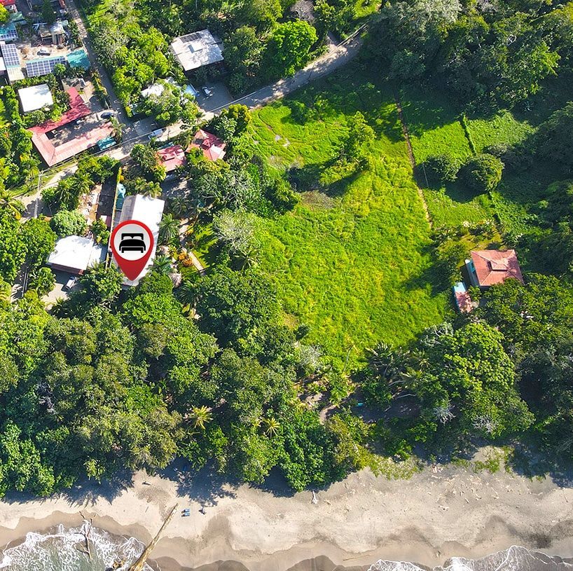 An aerial view of a lush green field with a car in the middle