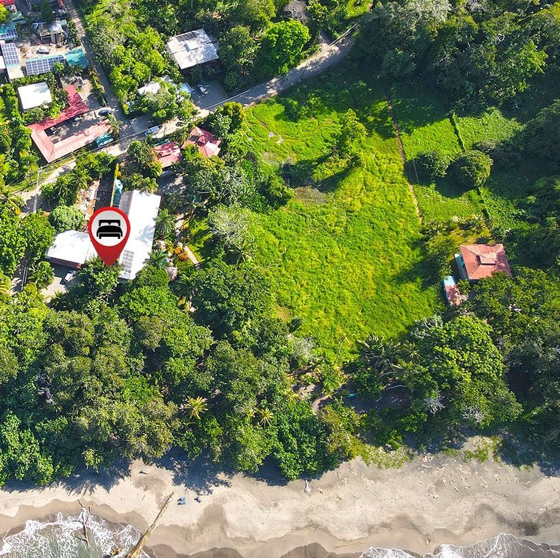 An aerial view of a residential area with a red pin pointing to a house