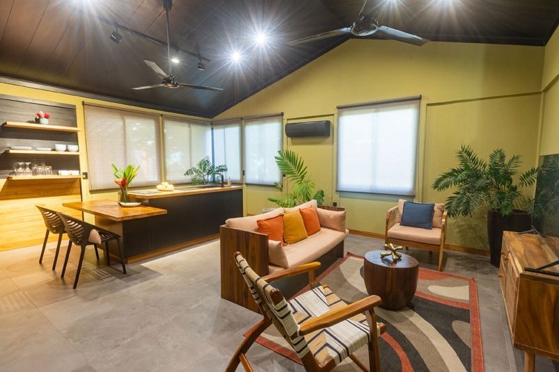 A living room filled with furniture and a ceiling fan.