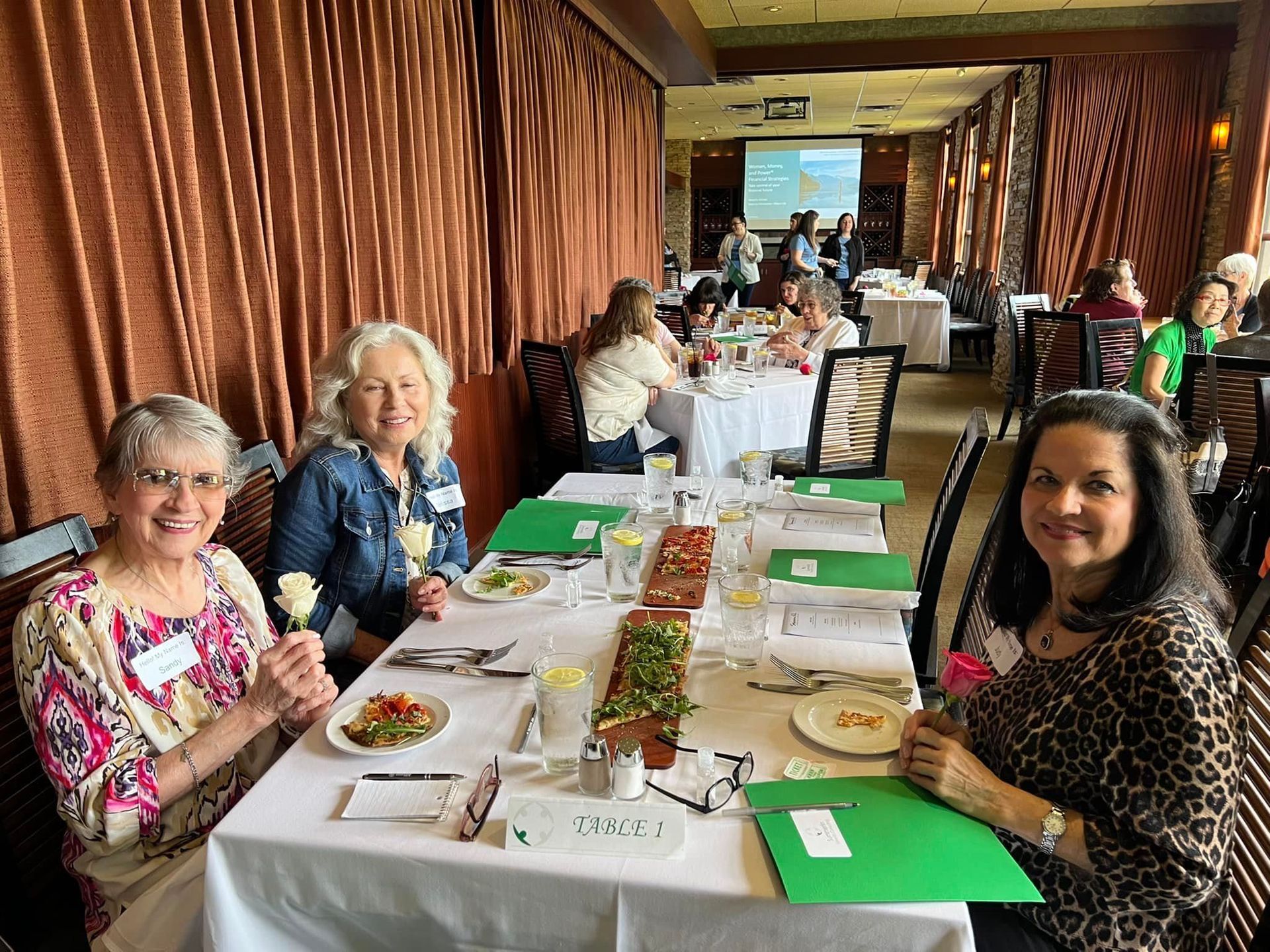 A group of women are sitting at a table in a restaurant.