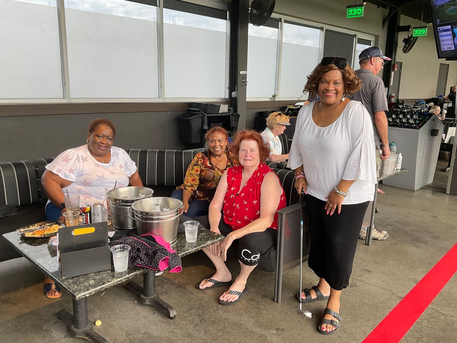 A group of women are sitting at a table in a restaurant.
