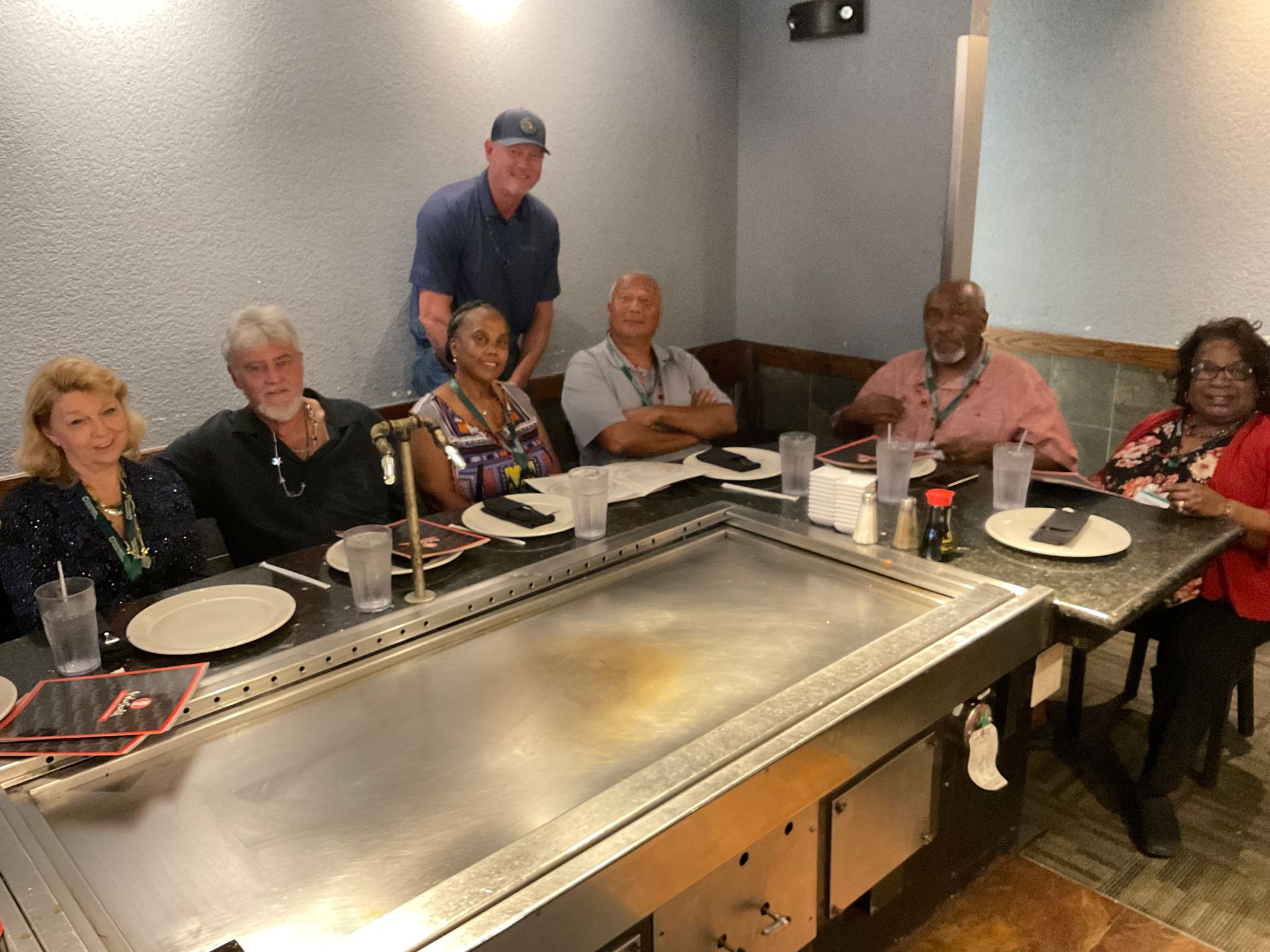 A group of Summerlin clients are sitting at a table preparing for dinner