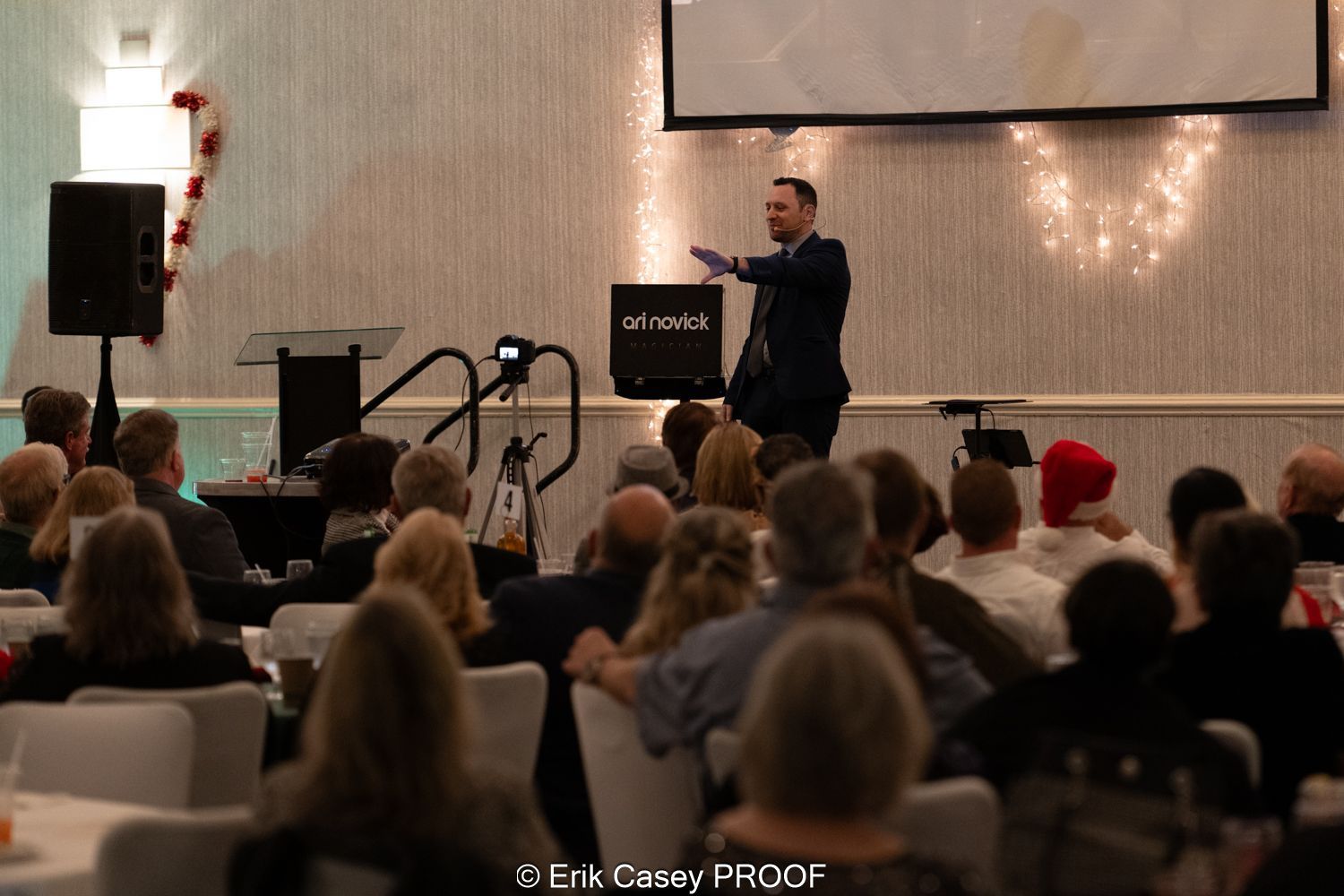 A man is giving a presentation to a crowd of people in a room.