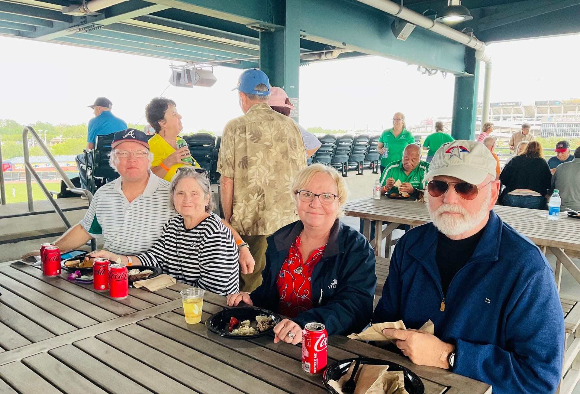 A group of people are sitting at a picnic table.