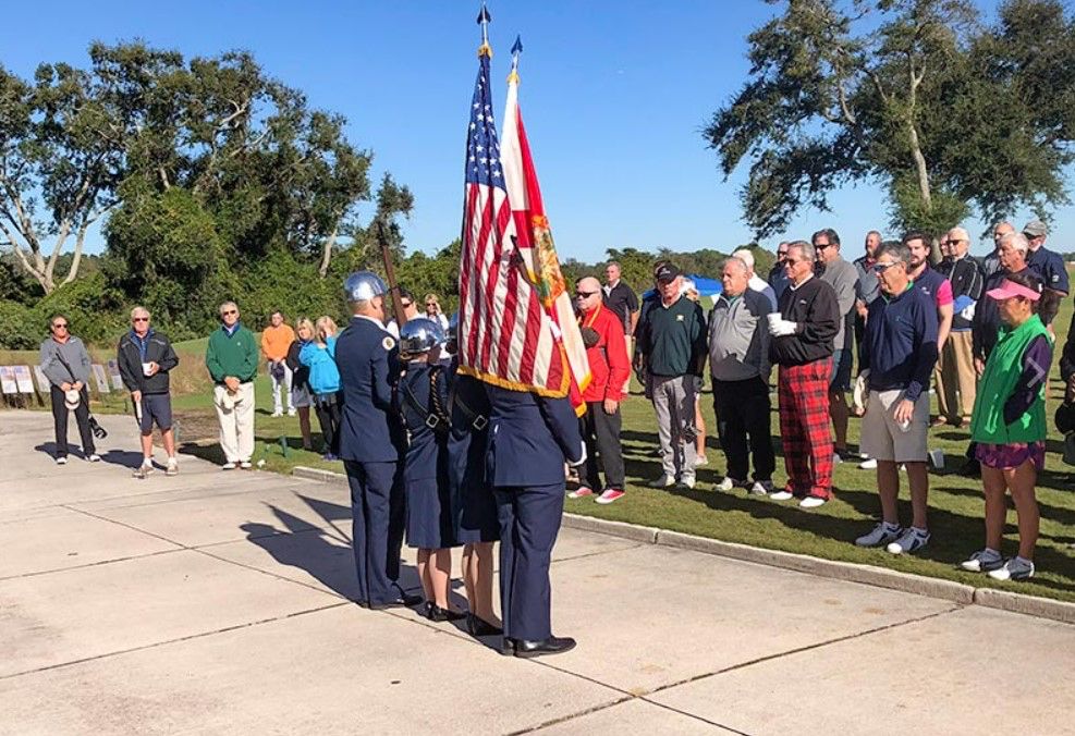 A group of people standing in front of an american flag