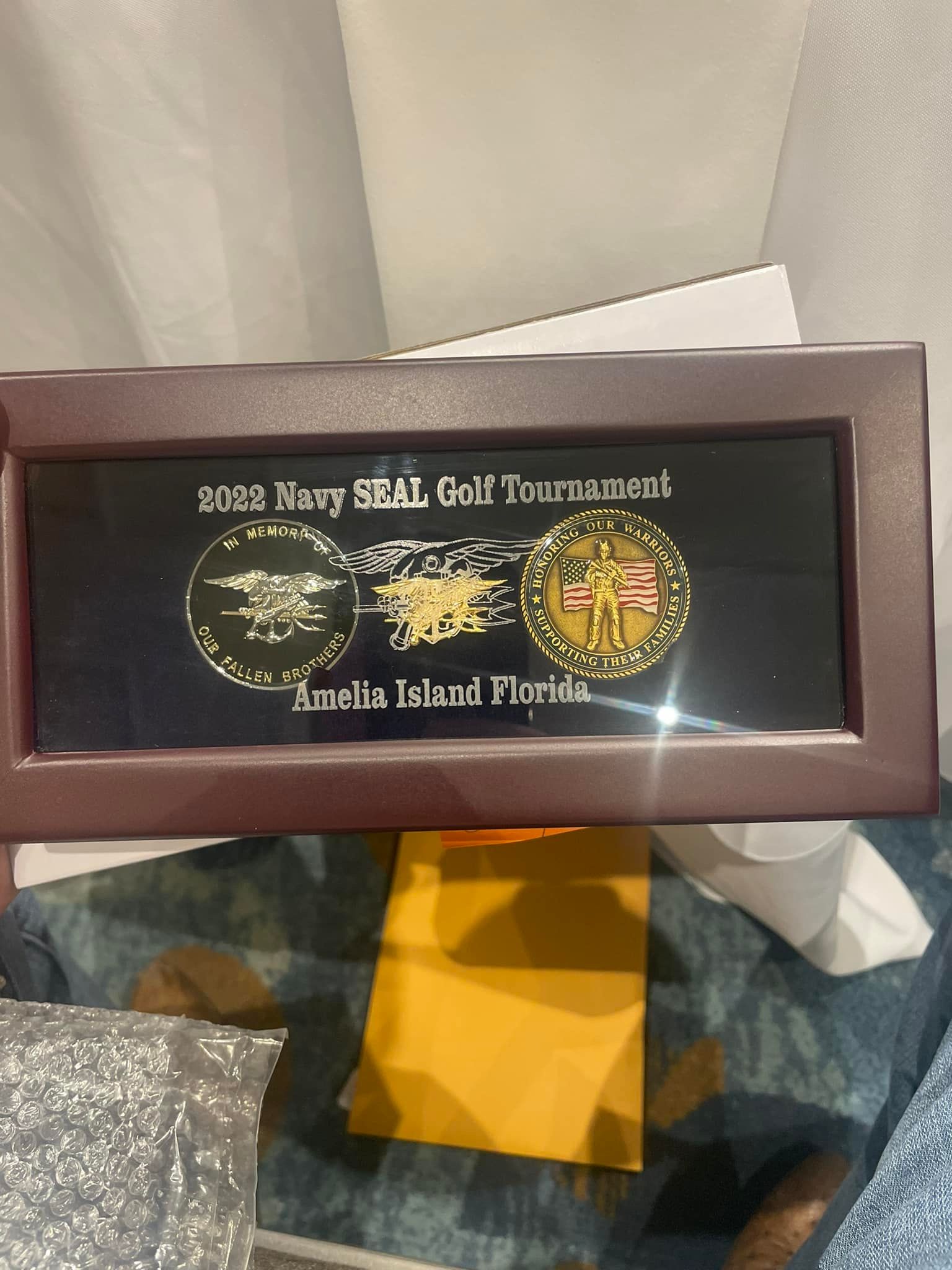 A framed picture of a navy seal golf tournament in amelia island florida
