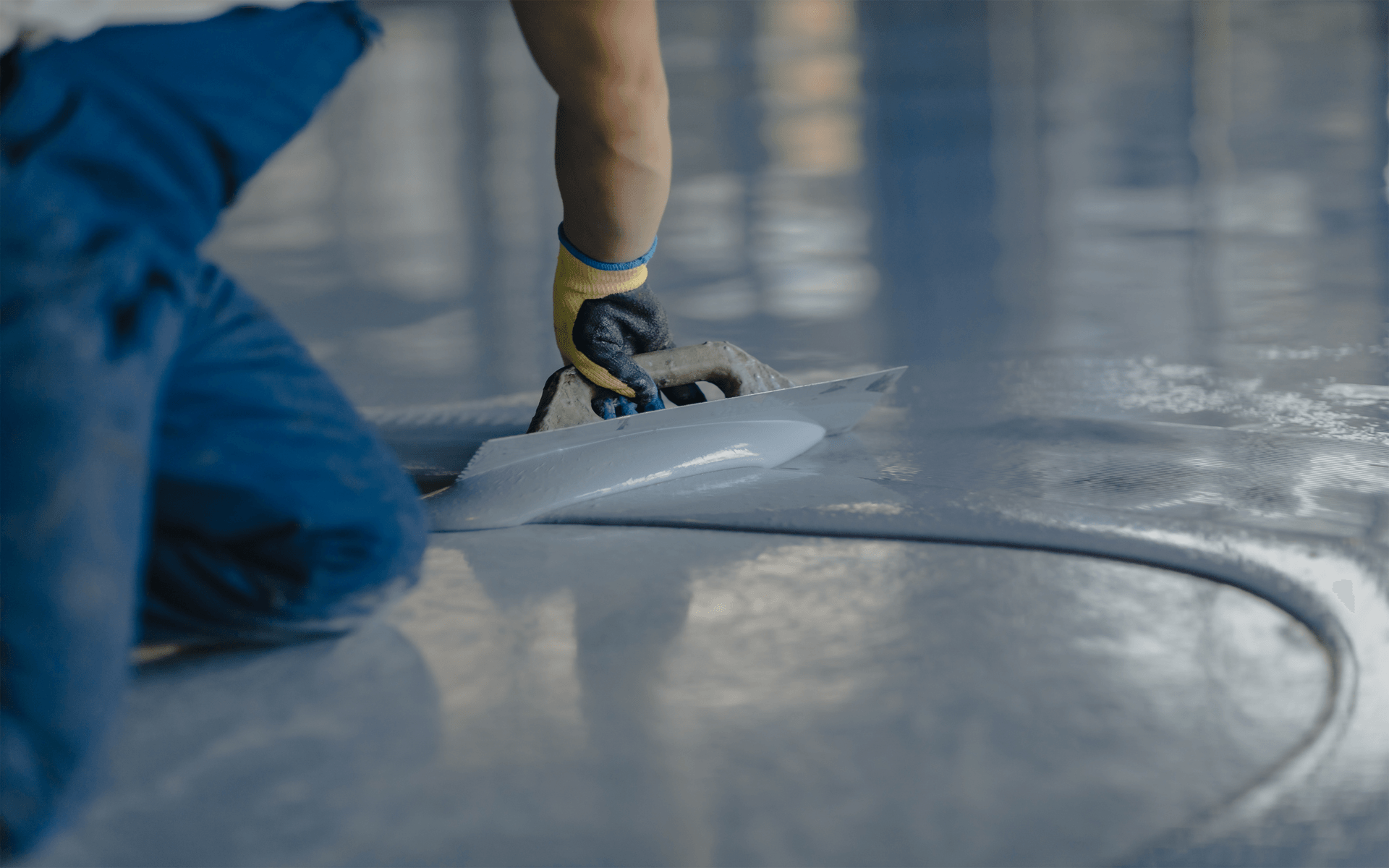 Man Applying Epoxy on Floor - Southport, QLD - Supremacy Concreters