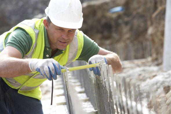 Man Measuring Thick Of Concrete - Southport, QLD - Supremacy Concreters